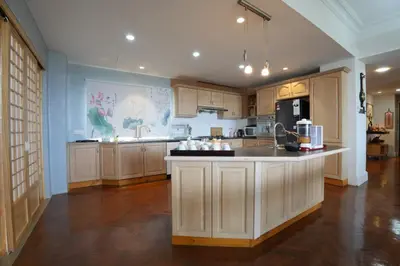 a large kitchen with wooden cabinets and a counter top at Japan Comfort Lifestyle Hokkaido in Ipoh
