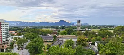 a city with trees and buildings and mountains in the background at Japan Comfort Lifestyle Hokkaido in Ipoh