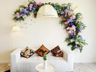 a living room with a white couch with a flower wreath at The Floral Retreat N3w Cozy High floor Beacon Executive Suite in George Town