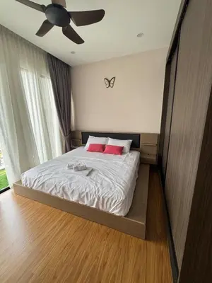 a bedroom with a bed with two red pillows at The Floral Retreat N3w Cozy High floor Beacon Executive Suite in George Town