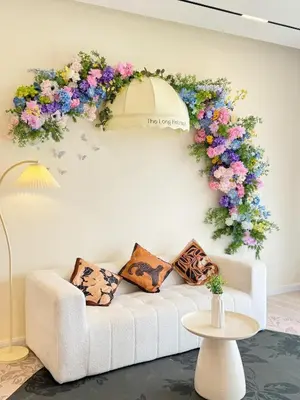 a living room with a white couch and flowers on the wall at The Floral Retreat N3w Cozy High floor Beacon Executive Suite in George Town