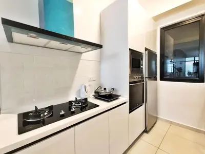 a white kitchen with a stove and a refrigerator at The Floral Retreat N3w Cozy High floor Beacon Executive Suite in George Town