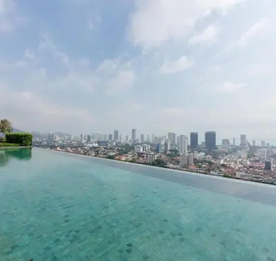 a infinity pool with a view of a city at The Floral Retreat N3w Cozy High floor Beacon Executive Suite in George Town