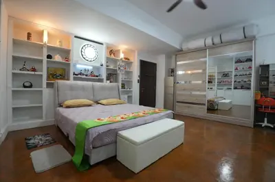 a bedroom with a bed and a clock on the wall at Japan Comfort Lifestyle Nagoya in Ipoh