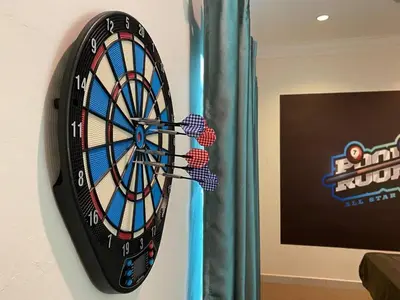 a dart board hanging on a wall next to a curtain at Dyra Homestay in Lumut in Lumut