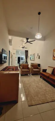 a large living room with couches and a tv at Ipoh Meru Landed Homestay TropiCasa 28 in Ipoh