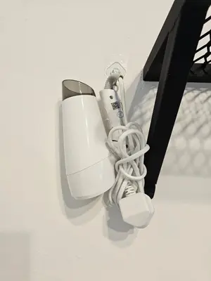 a white computer monitor with a cord plugged into it at Ipoh Meru Landed Homestay TropiCasa 28 in Ipoh