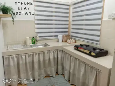 a kitchen counter with a sink and a window at MyHomestay Botani in Ipoh