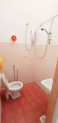 a bathroom with a toilet and a shower and a sink at MyHomestay Botani in Ipoh
