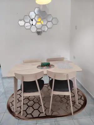 a table and two stools in a room at Suria Permai19 Homestay in Taiping