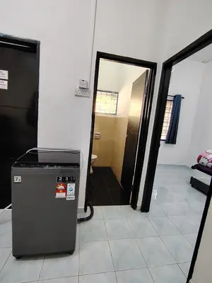 a room with a door open to a room with a refrigerator at Suria Permai19 Homestay in Taiping