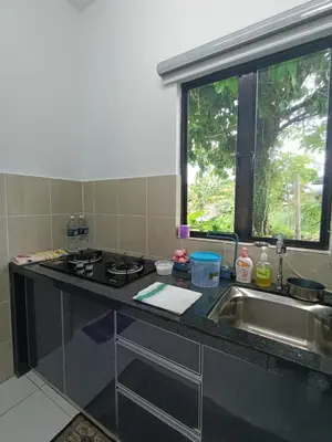 a kitchen counter with a sink and a window at Jemput Rezeki Homestay in Bayan Lepas