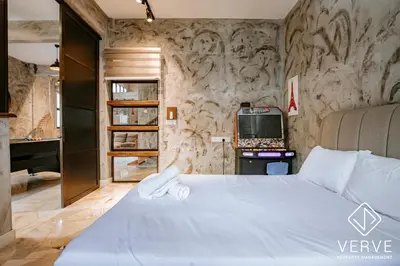 a bedroom with a white bed and a tv at R Private Club House 4B4B 16 pax by Verve in Ipoh