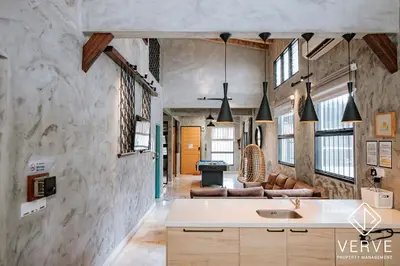 a kitchen with a sink and a living room at R Private Club House 4B4B 16 pax by Verve in Ipoh