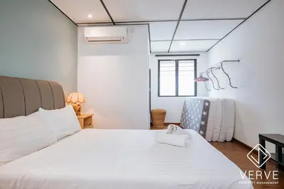 a bedroom with a large white bed and a window at R Private Club House 4B4B 16 pax by Verve in Ipoh