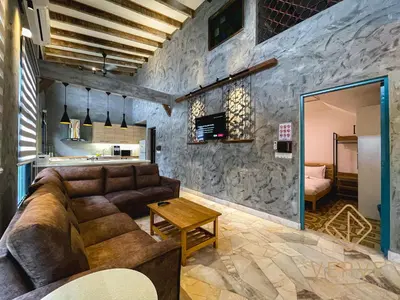 a living room with a couch and a table at R Private Club House 4B4B 16 pax by Verve in Ipoh