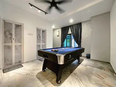 a pool table in a room with a ceiling fan at Ipoh C Private Club House by Verve EECH109 in Ipoh