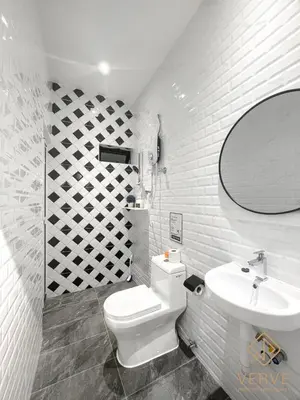 a white bathroom with a toilet and a sink at Ipoh C Private Club House by Verve EECH109 in Ipoh