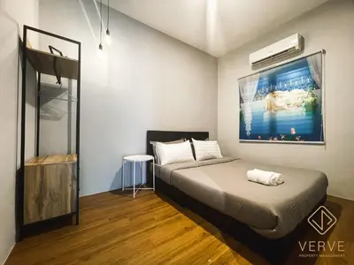 a bedroom with a bed with a painting on the wall at Ipoh C Private Club House by Verve EECH109 in Ipoh