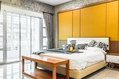 a bedroom with a large bed with a wooden headboard at Ipoh Lang Villa Premium Semi-D Villa by Verve in Ipoh