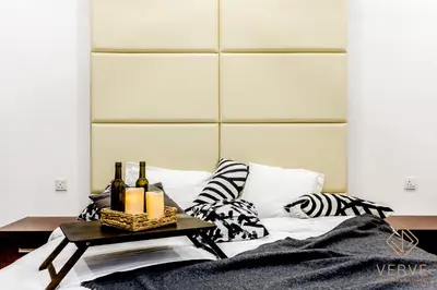 a bed with a table with bottles and candles on it at Ipoh Lang Villa Premium Semi-D Villa by Verve in Ipoh