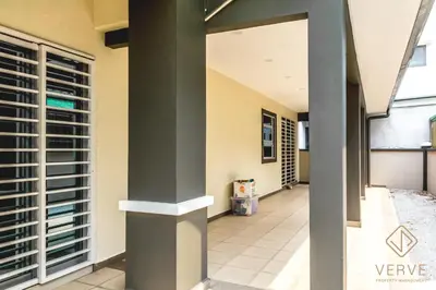 a hallway of a building with columns and a window at Ipoh Lang Villa Premium Semi-D Villa by Verve in Ipoh