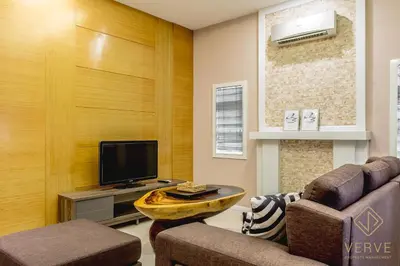 a living room with a couch and a tv at Ipoh Lang Villa Premium Semi-D Villa by Verve in Ipoh