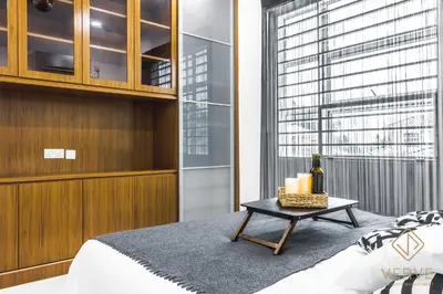 a bedroom with a bed and a table with candles at Ipoh Lang Villa Premium Semi-D Villa by Verve in Ipoh