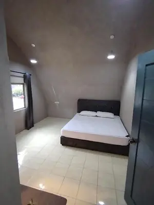 a small bedroom with a bed and a window at Dome Glamping Lojing Highlands in Ladang Pangoi