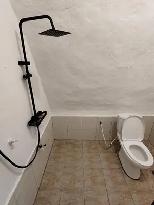 a bathroom with a shower and a toilet in it at Dome Glamping Lojing Highlands in Ladang Pangoi