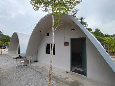 a small house with a tree in front of it at Dome Glamping Lojing Highlands in Ladang Pangoi