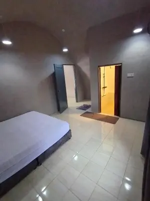a room with a bed and a hallway with two doors at Dome Glamping Lojing Highlands in Ladang Pangoi