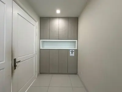 a hallway with a wooden cabinet and a door at Luxury 5BR stay walk to beach & Night market fun in Batu Ferringhi