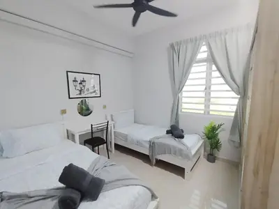 a bedroom with two beds and a ceiling fan at The Paloh Town Suites 4R2B with 2 carpark by IWH Suites in Ipoh