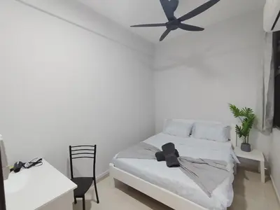 a white bedroom with a black ceiling fan at The Paloh Town Suites 4R2B with 2 carpark by IWH Suites in Ipoh