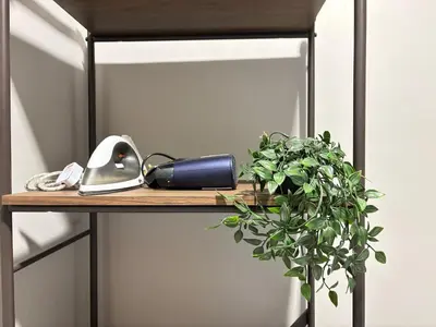 a shelf with a phone and a plant on it at The Paloh Town Suites 4R2B with 2 carpark by IWH Suites in Ipoh