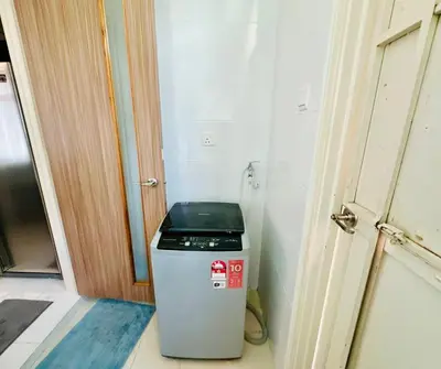 a small refrigerator in the corner of a room at Large Family Villa Beach & Night Market Steps Away 20 Pax in Batu Ferringhi