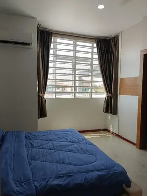 a bedroom with a blue bed and a large window at 28 Home in Pusing