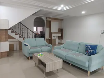 a living room with two blue couches and a table at 28 Home in Pusing