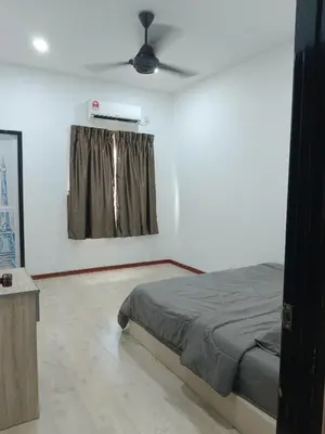 a bedroom with a bed and a ceiling fan at 28 Home in Pusing