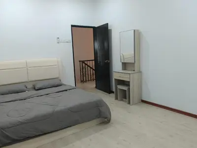 a bedroom with a bed and a desk and a mirror at 28 Home in Pusing