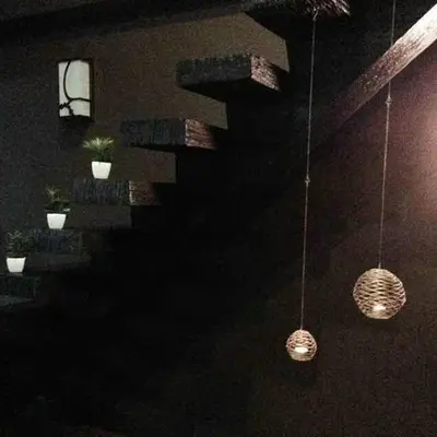 two hanging lights in a dark room with a staircase at 30A Studio Room Medan Ipoh with Pool Table in Ipoh