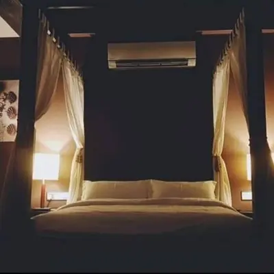 a bedroom with a bed with a canopy at 30A Studio Room Medan Ipoh with Pool Table in Ipoh
