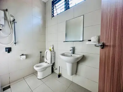 a bathroom with a toilet and a sink and a mirror at Exclusive Luxury 2MIN Walk to Beach & Night Market in Batu Ferringhi