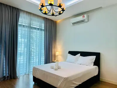 a bedroom with a large bed and a chandelier at Exclusive Luxury 2MIN Walk to Beach & Night Market in Batu Ferringhi