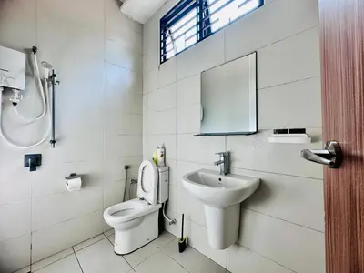 a bathroom with a toilet and a sink at Exclusive Luxury 2MIN Walk to Beach & Night Market in Batu Ferringhi