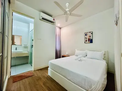 a white bedroom with a bed and a bathroom at Exclusive Luxury 2MIN Walk to Beach & Night Market in Batu Ferringhi