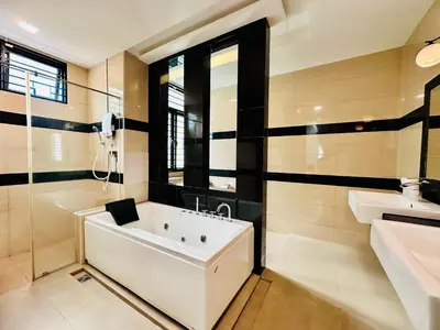 a white bath tub in a bathroom with a sink at Exclusive Luxury 2MIN Walk to Beach & Night Market in Batu Ferringhi