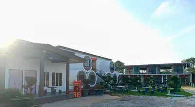 a building with a lot of plants in front of it at Olly de Home Ent in Batu Gajah