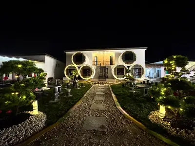 a building with christmas wreaths on it at night at Olly de Home Ent in Batu Gajah
